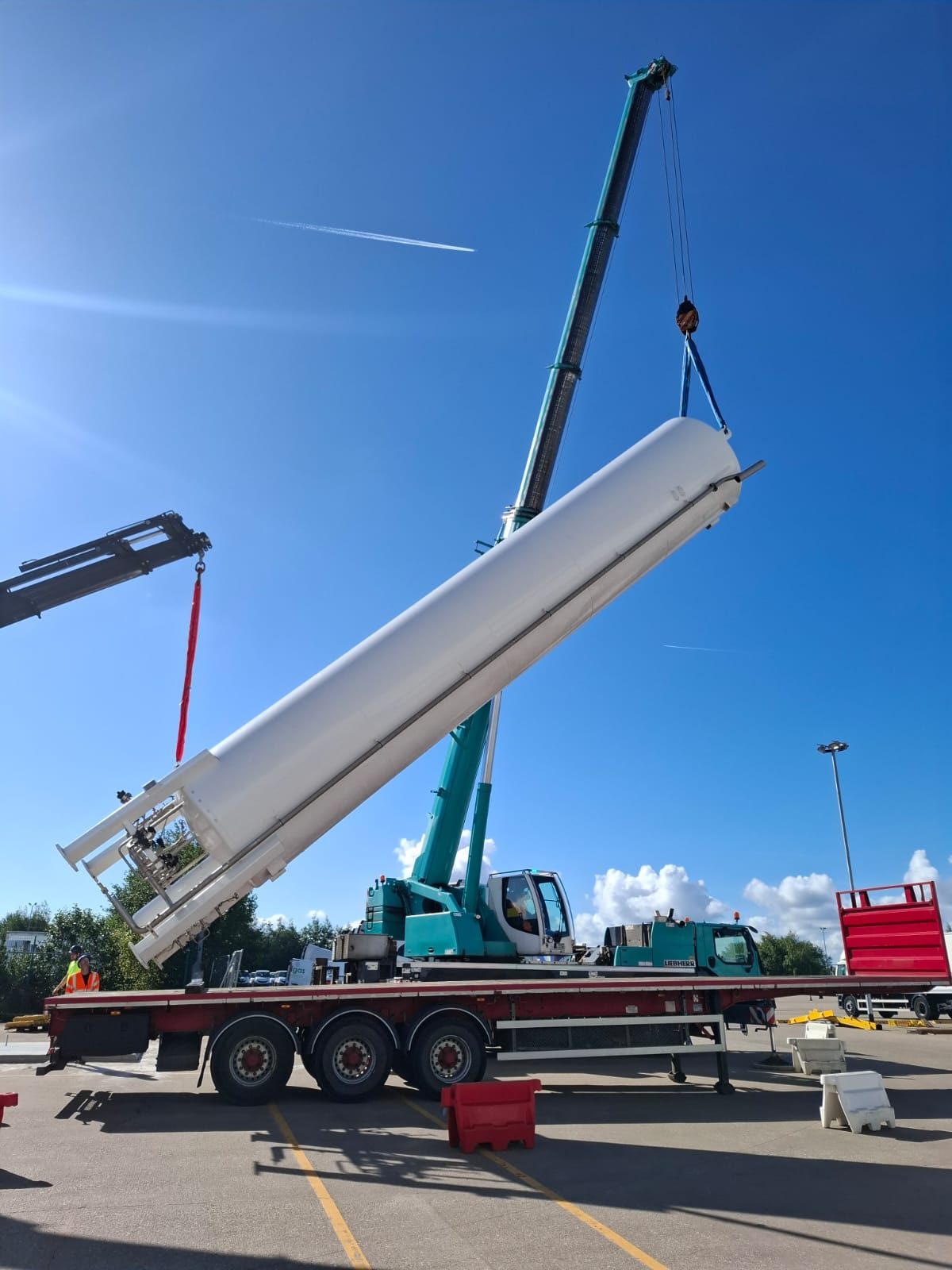Mobile crane lifting a large steel beam during installation