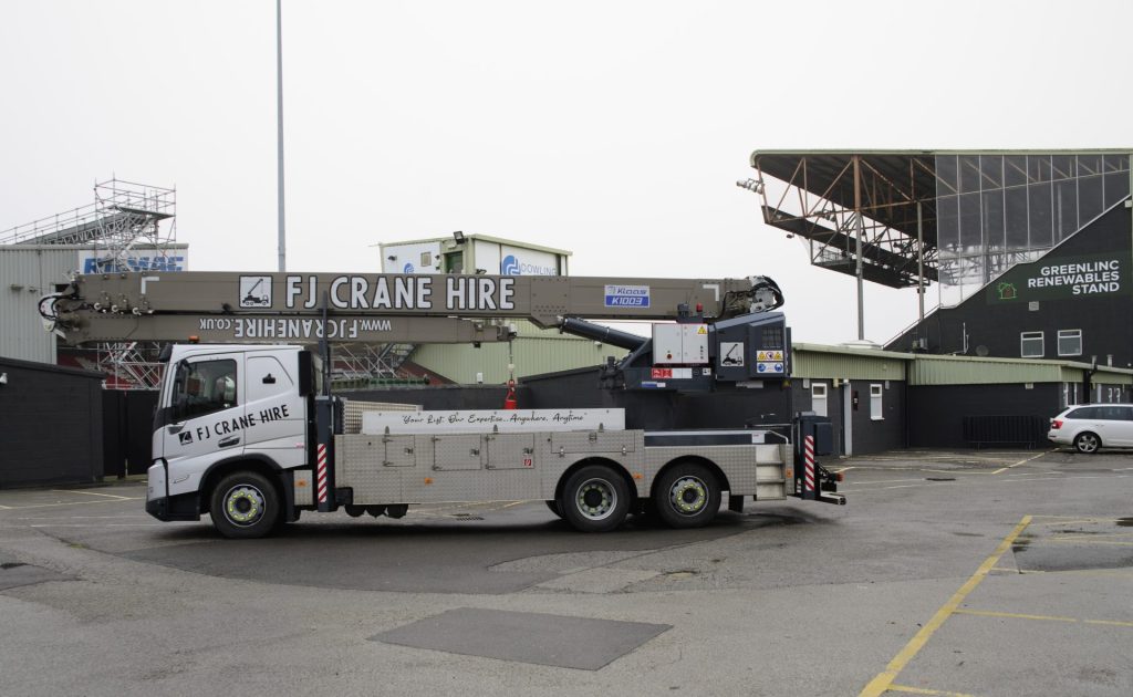 FJ Crane Hire heavy crane parked at depot entrance